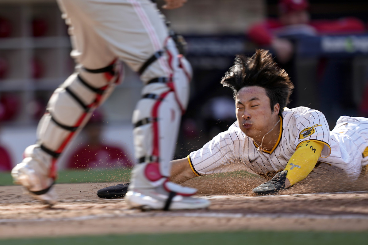Padres shortstop Ha-Seong Kim slides into home plate to score all the way from first base on Austin Nola’s RBI single.