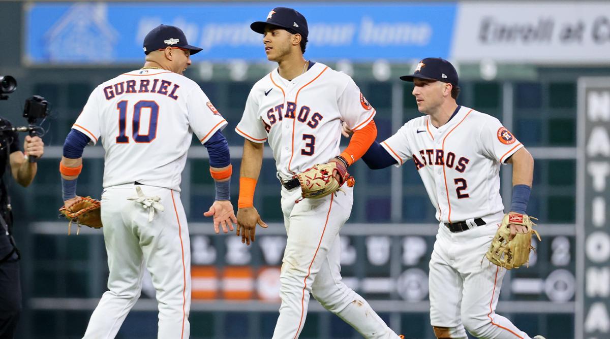 Oct 19, 2022; Houston, Texas, USA; Houston Astros first baseman Yuli Gurriel (10) and shortstop Jeremy Pena (3) and third baseman Alex Bregman (2) celebrate after their win against the New York Yankees in game one of the ALCS for the 2022 MLB Playoffs at Minute Maid Park.