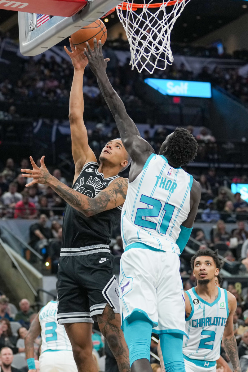 Oct 19, 2022; San Antonio, Texas, USA; Charlotte Hornets forward JT Thor (21) blocks a shot by San Antonio Spurs forward Jeremy Sochan (10) in the first half at the AT&T Center. Mandatory Credit: Daniel Dunn-USA TODAY Sports