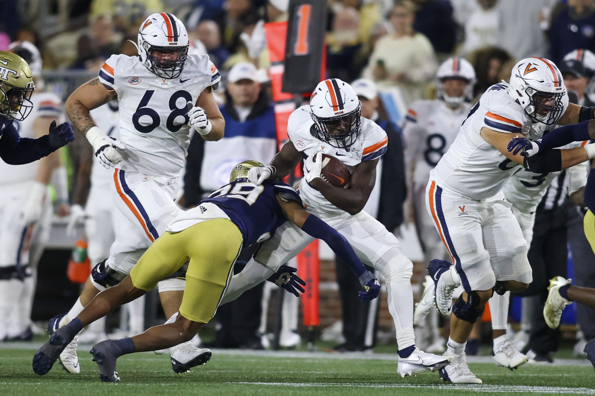 Virginia Cavaliers running back Xavier Brown (20) is tackled by Georgia Tech Yellow Jackets defensive back Clayton Powell-Lee (29) in the first half at Bobby Dodd Stadium.