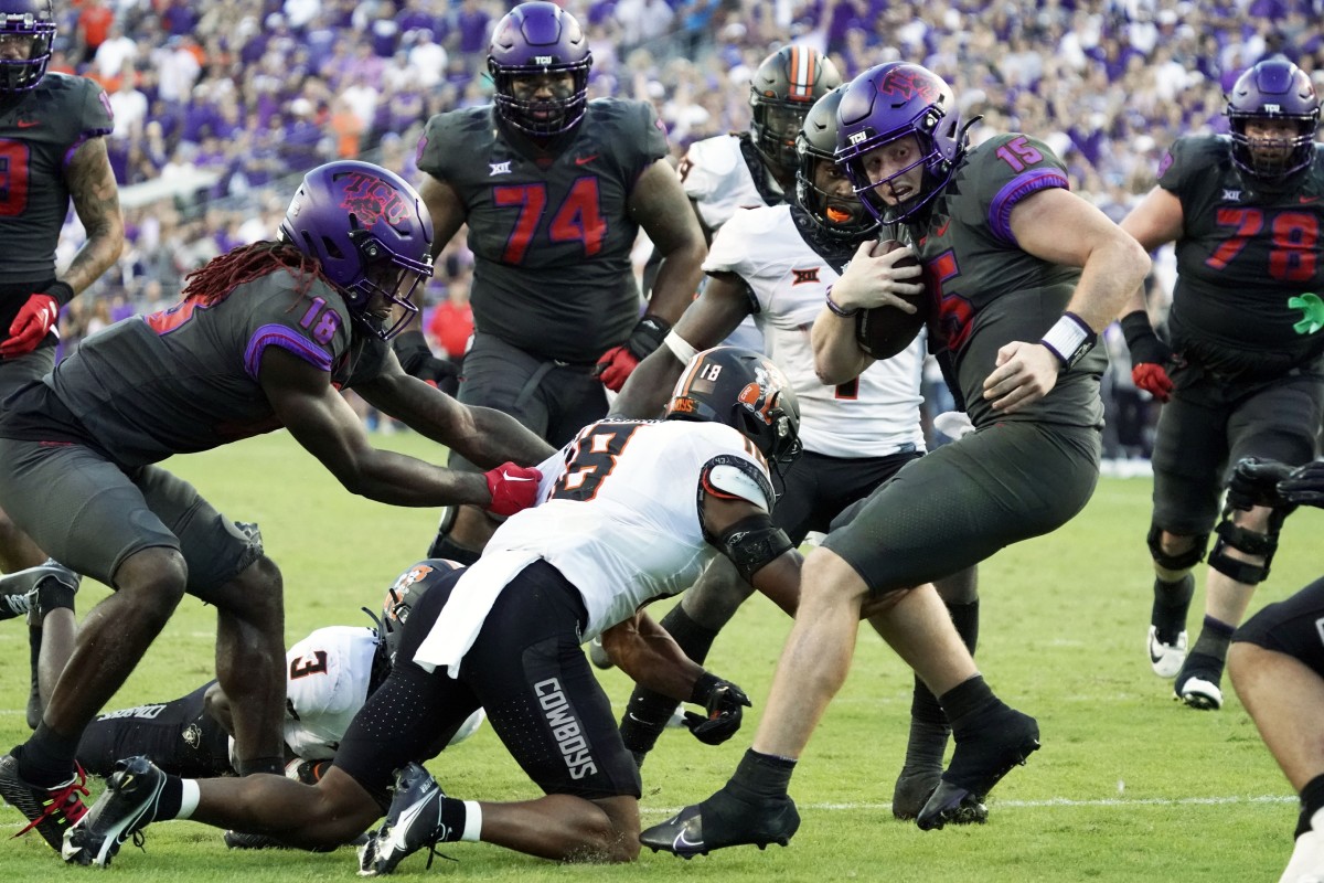 TCU Horned Frogs quarterback Max Duggan (15) carries the ball in overtime against the Oklahoma State Cowboys during the second half at Amon G. Carter Stadium.