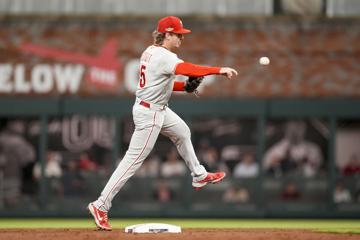 Phillies shortstop Bryson Stott throws to first base after fielding a grounder.