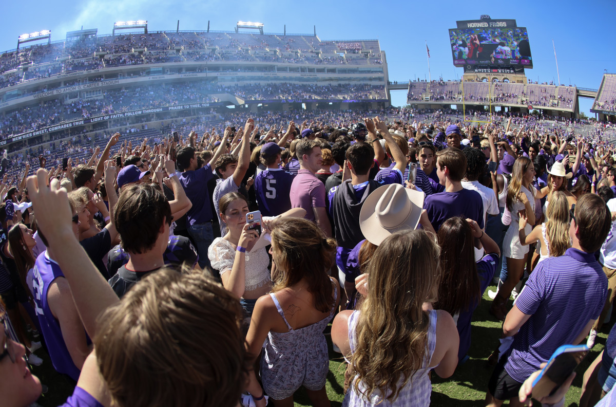 TCU fans storm the field after a comeback win against Oklahoma State.
