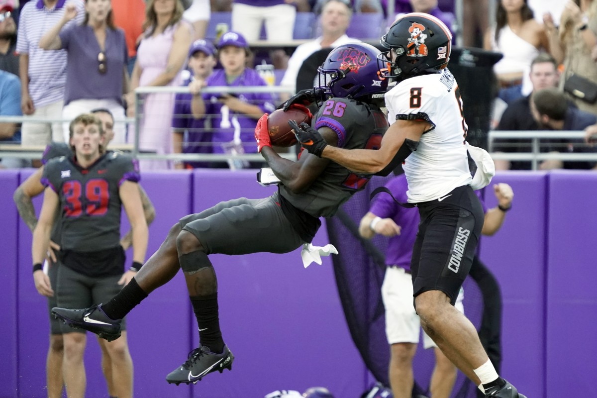 TCU Horned Frogs safety Bud Clark (26) makes the interception in front of Oklahoma State Cowboys wide receiver Braydon Johnson (8) during the second half at Amon G. Carter Stadium