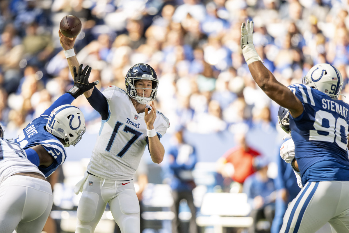 Oct 2, 2022; Indianapolis, Indiana, USA; Tennessee Titans quarterback Ryan Tannehill (17) throws a pass between Indianapolis Colts defensive end Kwity Paye (51) and Indianapolis Colts defensive tackle Grover Stewart (90) during the first quarter at Lucas Oil Stadium.