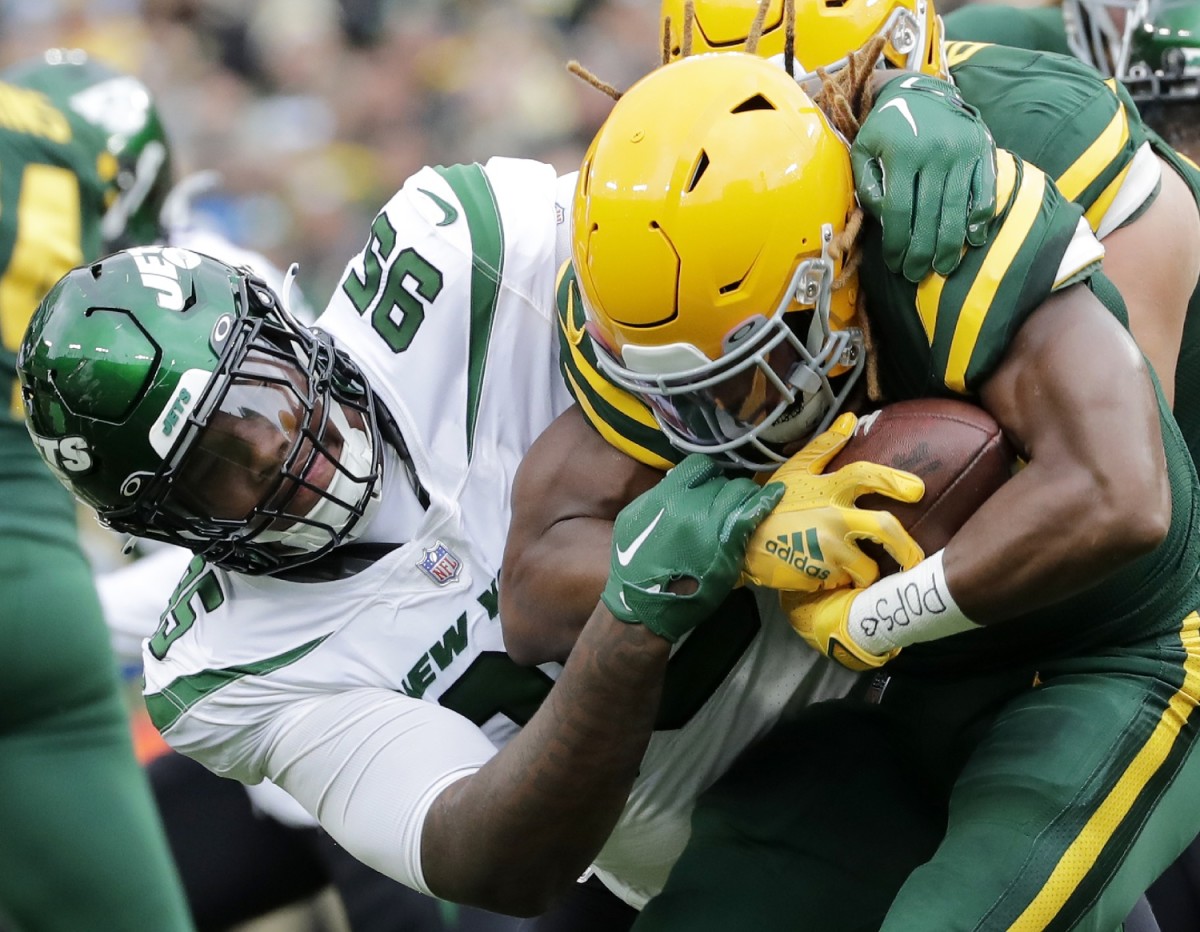 Oct 16, 2022; Green Bay, Wisconsin, USA; New York Jets defensive tackle Quinnen Williams (95) tackles Green Bay Packers running back Aaron Jones (33) during the first half at Lambeau Field. Mandatory Credit: Wm. Glasheen/Appleton Post-Crescent-USA TODAY NETWORK