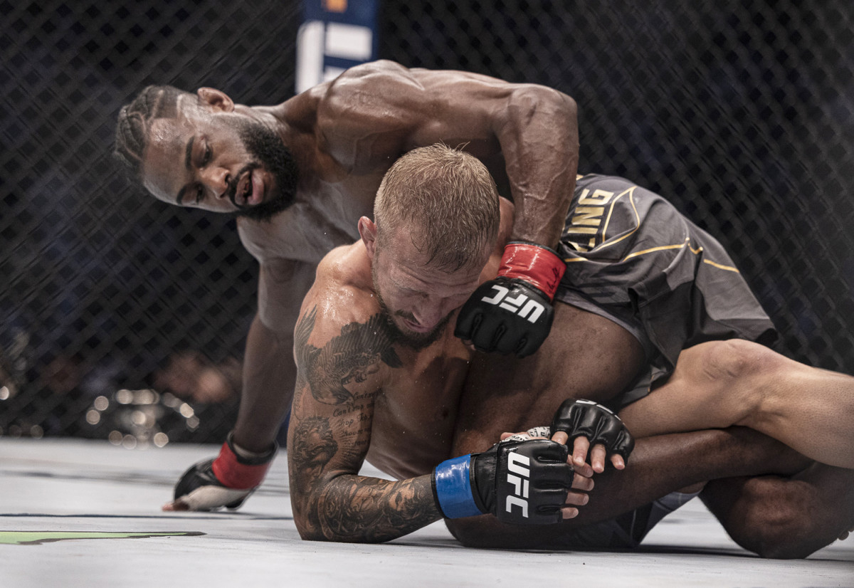 Aljamain Sterling (red gloves) and T.J. Dillashaw (blue gloves) during UFC 280 at Etihad Arena.