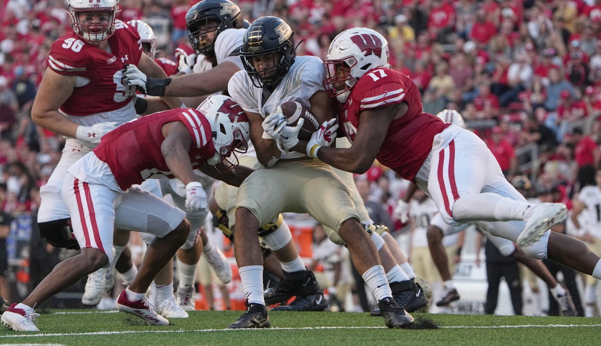 Purdue running back Devin Mockobee (45) is tackled by Wisconsin cornerback Max Lofy (12) and Darryl Peterson (17) during the fourth quarter of their game at Camp Randall Stadium Saturday, October 22, 2022, in Madison, Wis. 