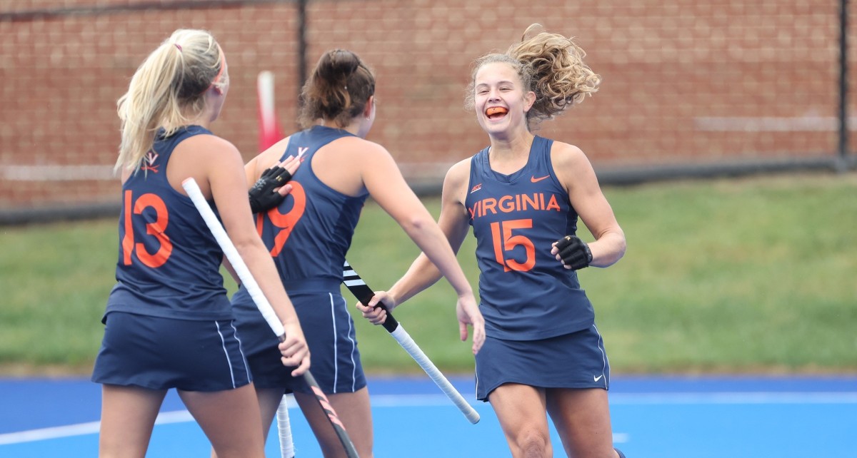 Laura Janssen, Adele Iacobucci, and Dani Mendez-Trendler celebrate after a goal for the Virginia field hockey team.