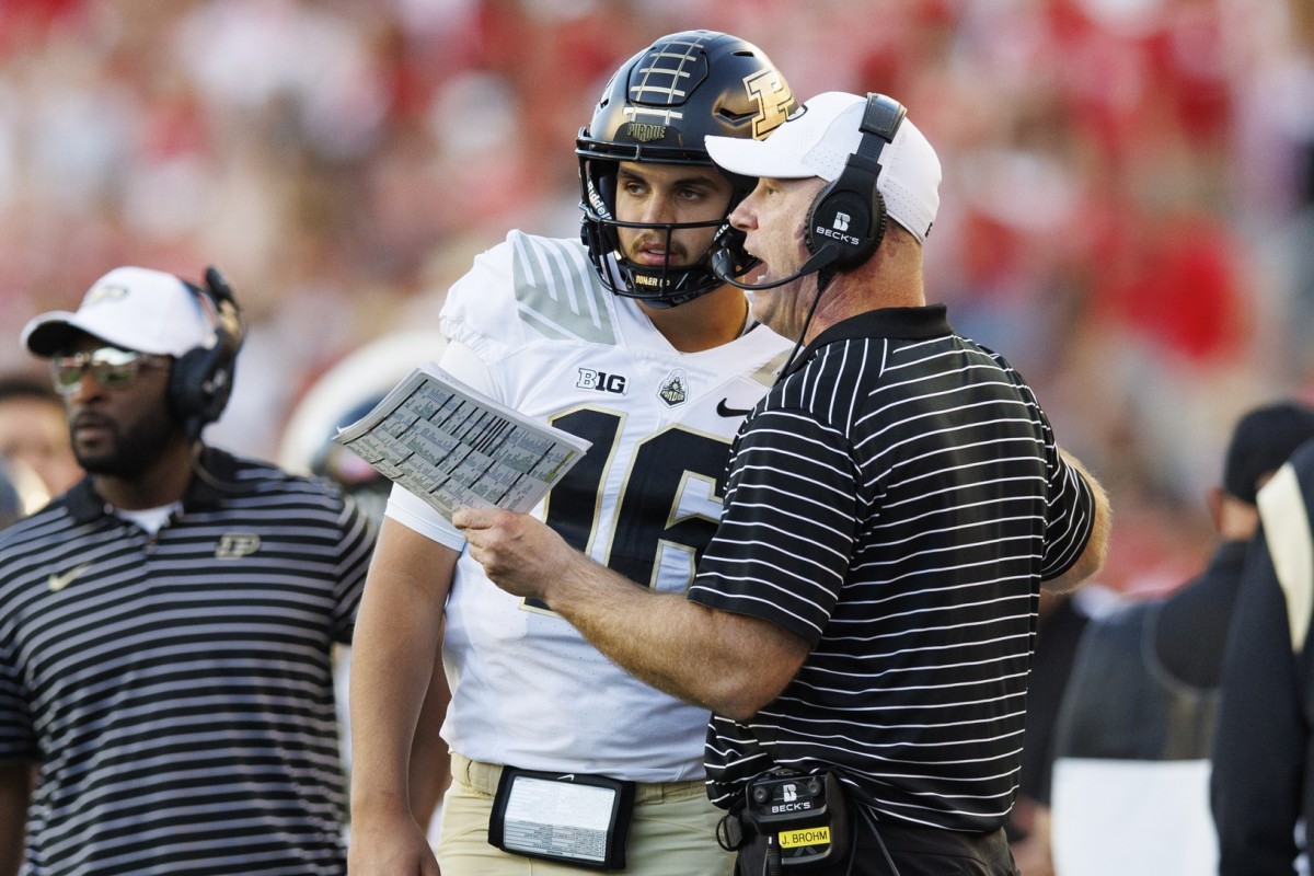 Oct 22, 2022; Madison, Wisconsin, USA; Purdue Boilermakers head coach Jeff Brohm talks with quarterback Aidan O'Connell (16) during the fourth quarter against the Wisconsin Badgers at Camp Randall Stadium.