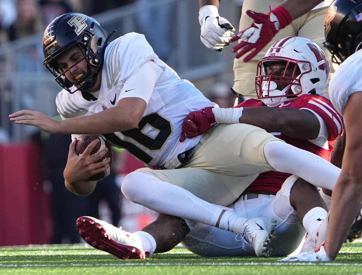 Wisconsin linebacker Jake Chaney (36) sacks Purdue quarterback Aidan O'Connell (16) during the third quarter of their game at Camp Randall Stadium Saturday, October 22, 2022, in Madison, Wis. Wisconsin beat Purdue 35-24.