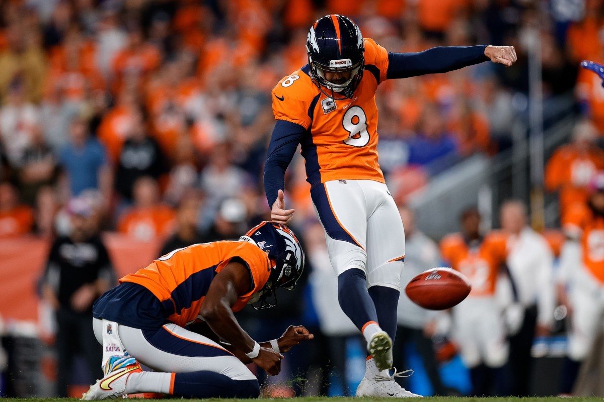 Denver Broncos place kicker Brandon McManus (8) kicks a field goal on a hold from punter Corliss Waitman (17) in the third quarter against the Indianapolis Colts at Empower Field at Mile High.