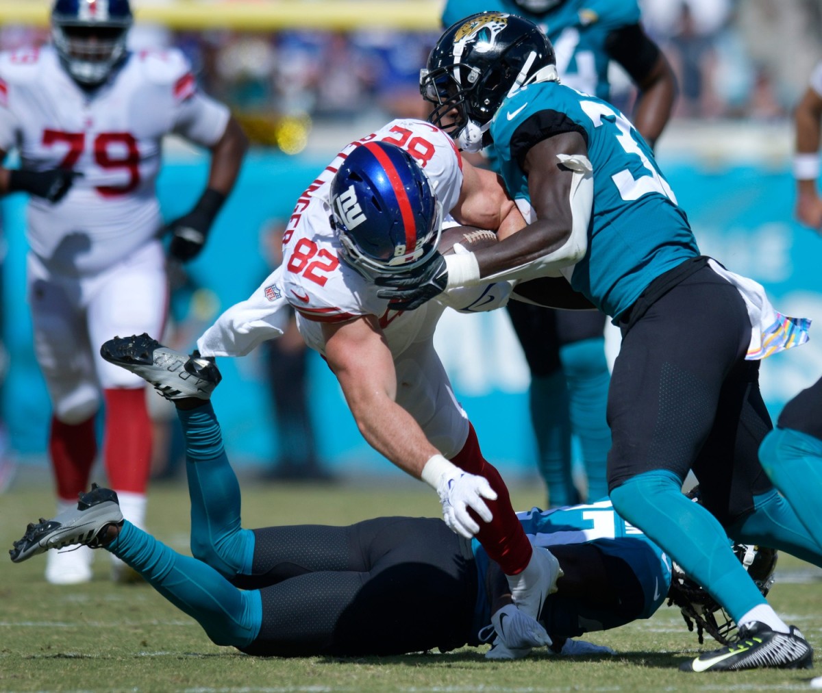 Jacksonville Jaguars linebacker Devin Lloyd (33) makes the tackle on New York Giants tight end Daniel Bellinger (82) during late second quarter action. Bellinger went out of the game with an injury to his face on the play. The Jacksonville Jaguars hosted the New York Giants at TIAA Bank Field in Jacksonville, FL Sunday, October 23, 2022. The Jaguars trailed at the half 11 to 13.