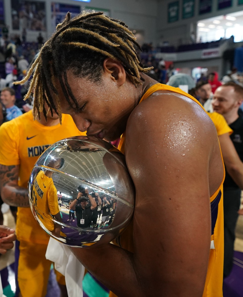 Montverde Academy Eagles forward Malik Reneau (14) kisses the trophy after defeating Link Academy Lions and winning the Geico High School National Championship at Suncoast Credit Union Arena.