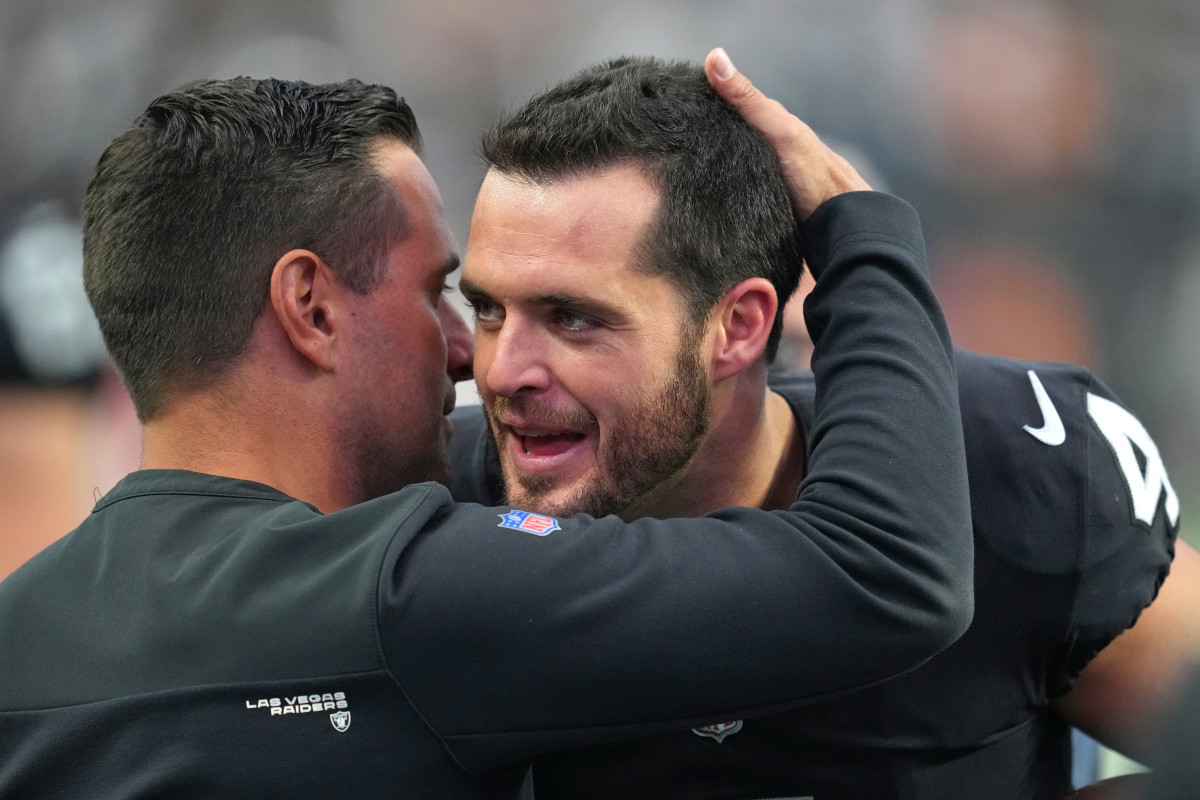 Las Vegas Raiders quarterback Derek Carr (4) is congratulated by Las Vegas Raiders General Manager Dave Ziegler after the Raiders defeated the Houston Texans 38–20 at Allegiant Stadium.