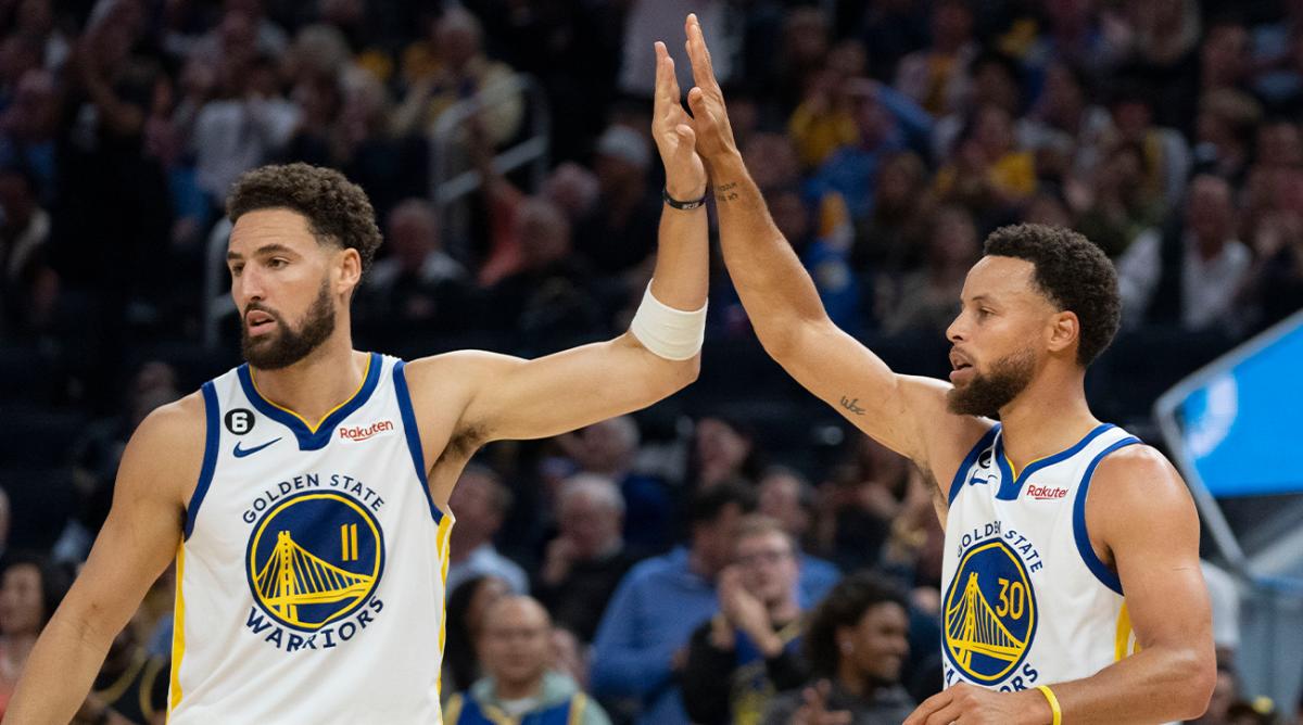 October 18, 2022; San Francisco, California, USA; Golden State Warriors guard Klay Thompson (11) high-fives guard Stephen Curry (30) against the Los Angeles Lakers during the second quarter at Chase Center.