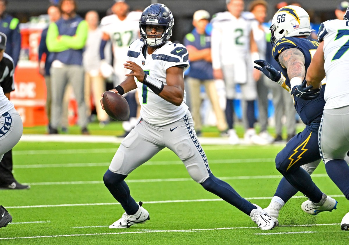 Oct 23, 2022; Inglewood, California, USA; Seattle Seahawks quarterback Geno Smith (7) is sacked by Los Angeles Chargers defensive end Morgan Fox (56) in the second half at SoFi Stadium.