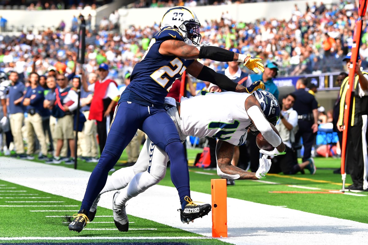 Oct 23, 2022; Inglewood, California, USA; Seattle Seahawks wide receiver DK Metcalf (14) is unable to hold onto a pass against the defense of Los Angeles Chargers cornerback J.C. Jackson (27) during the first half at SoFi Stadium.