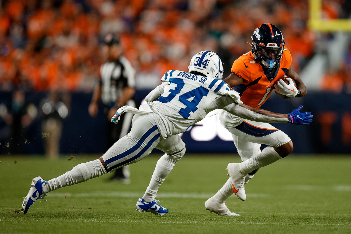 Oct 6, 2022; Denver, Colorado, USA; Denver Broncos wide receiver KJ Hamler (1) runs the ball under pressure from Indianapolis Colts cornerback Isaiah Rodgers Sr. (34) in the second quarter at Empower Field at Mile High.