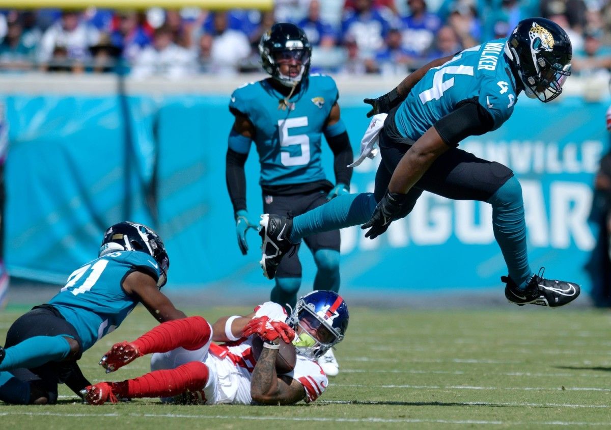 Jacksonville Jaguars linebacker Travon Walker (44) hurdles New York Giants wide receiver Wan'Dale Robinson (17) after a short pass play early in the first quarter. The Jacksonville Jaguars hosted the New York Giants at TIAA Bank Field in Jacksonville, FL Sunday, October 23, 2022. The Jaguars trailed at the half 11 to 13. [Bob Self/Florida Times-Union] Jki 102322 Hsfb Bs Jaguars Vs Giants 39