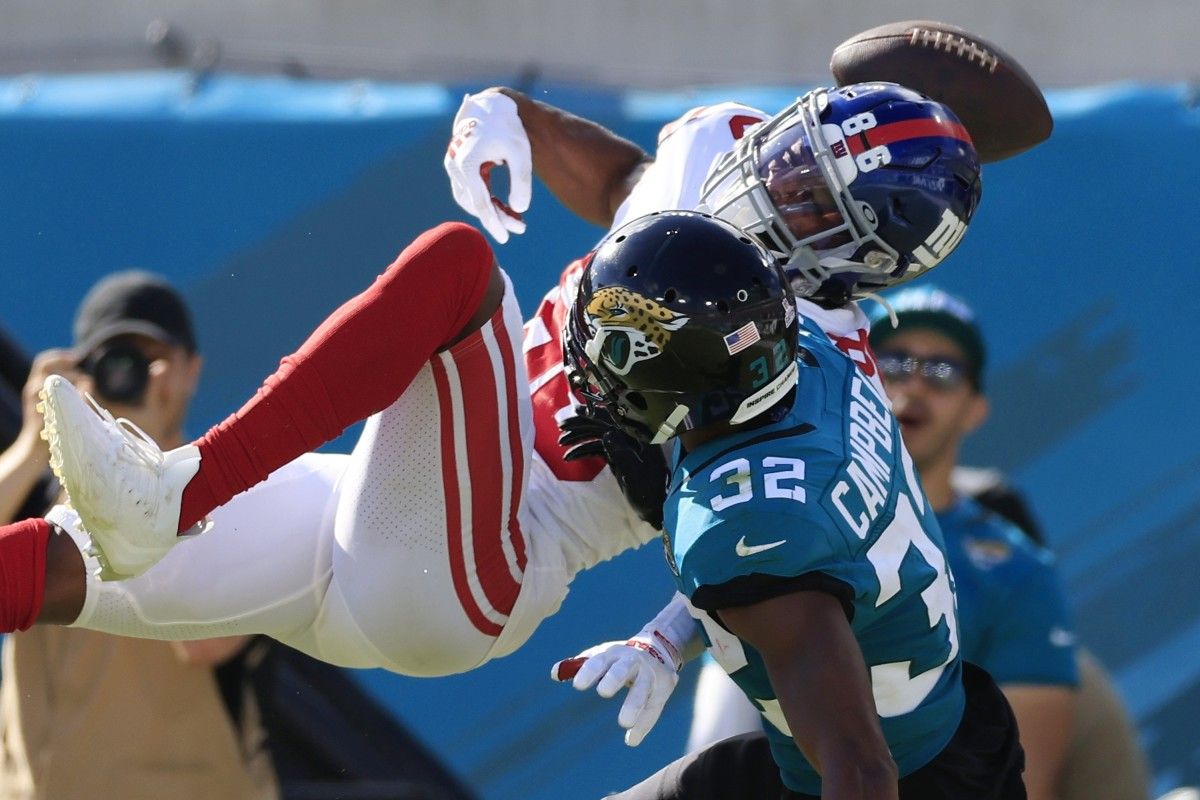 Jacksonville Jaguars cornerback Tyson Campbell (32) commits a pass interference penalty on New York Giants wide receiver Darius Slayton (86) setting up a touchdown drive for the Giants during the fourth quarter of a regular season NFL football matchup Sunday, Oct. 23, 2022 at TIAA Bank Field in Jacksonville. The New York Giants defeated the Jacksonville Jaguars 23-17. [Corey Perrine/Florida Times-Union] Jki 102322 Giants Jags Cp 27