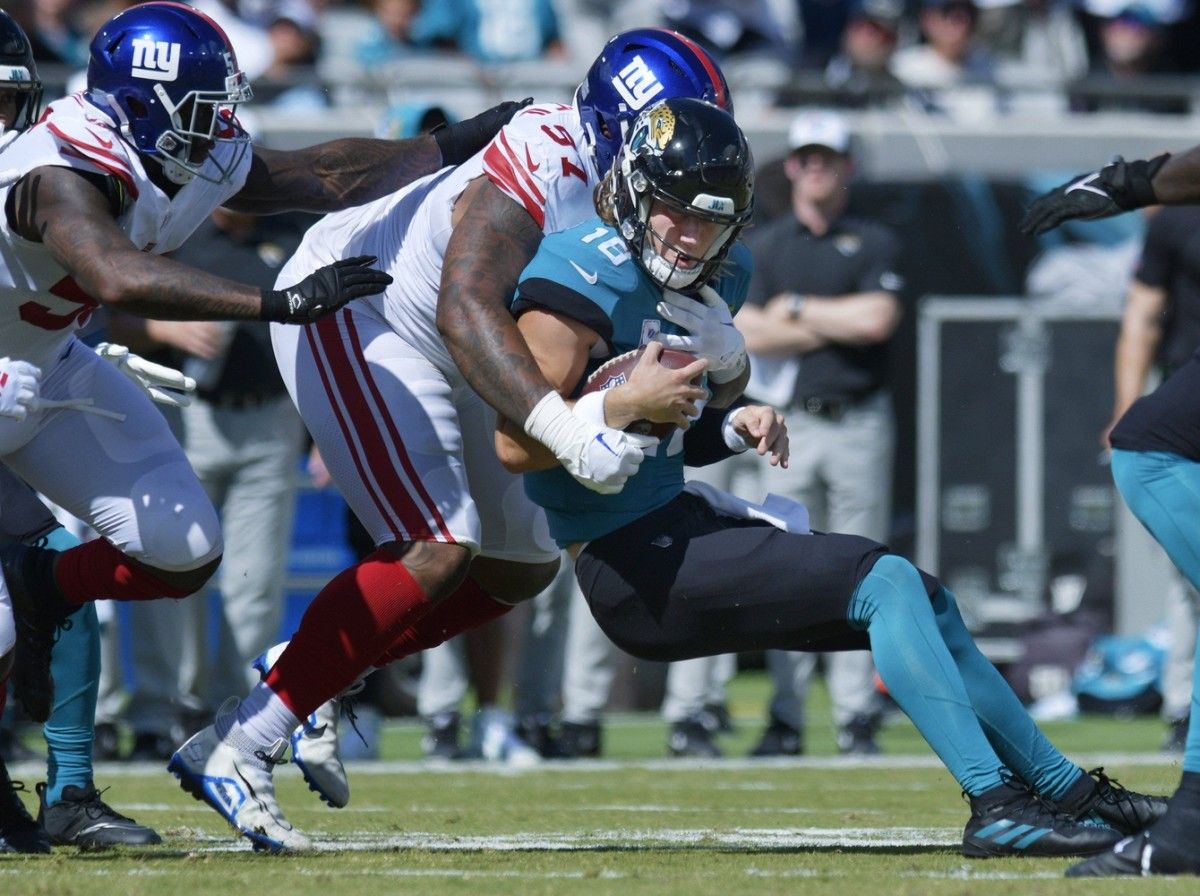 Jacksonville Jaguars quarterback Trevor Lawrence (16) is brought down by New York Giants defensive tackle Dexter Lawrence (97) on a one yard scramble late in the first quarter. The Jacksonville Jaguars hosted the New York Giants at TIAA Bank Field in Jacksonville, FL Sunday, October 23, 2022. The Jaguars trailed at the half 11 to 13. [Bob Self/Florida Times-Union] Jki 102322 Hsfb Bs Jaguars 22