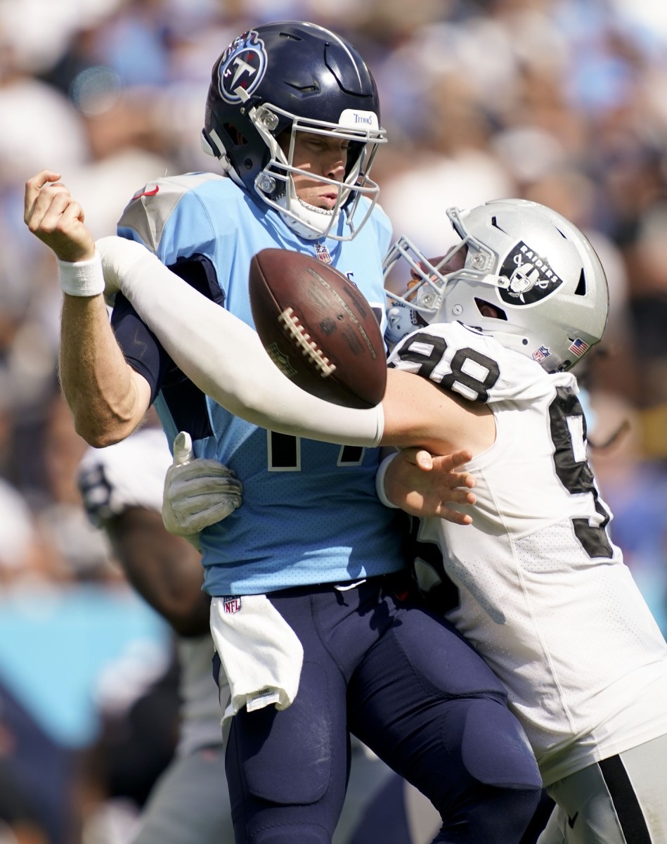 Tennessee Titans quarterback Ryan Tannehill (17) fumbles the ball after getting hit by Las Vegas Raiders defensive end Maxx Crosby (98). Mandatory Credit: George Walker IV-USA TODAY Sports