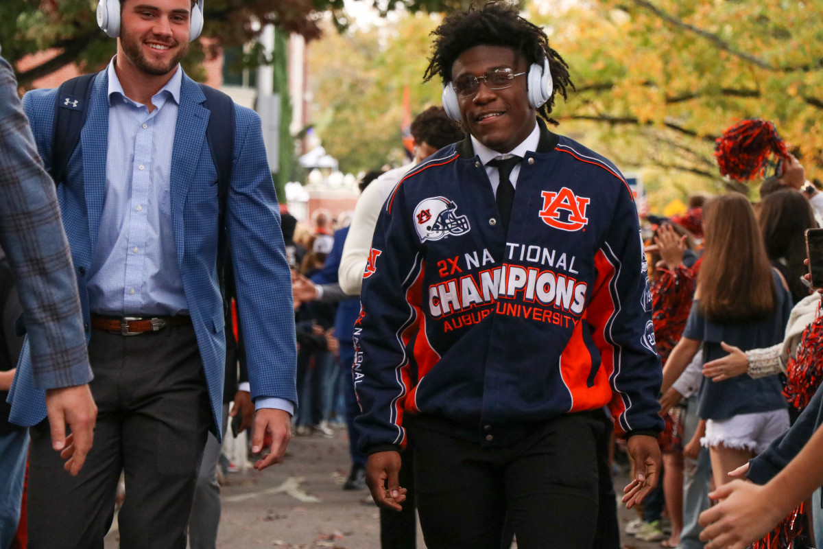 Damari Alston shows off a throwback Auburn jacket during Tiger Walk.