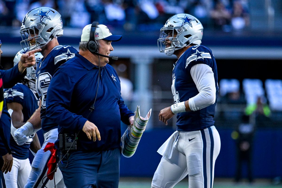 Dallas Cowboys coach Mike McCarthy smiles as quarterback Dak Prescott heads to the sideline.