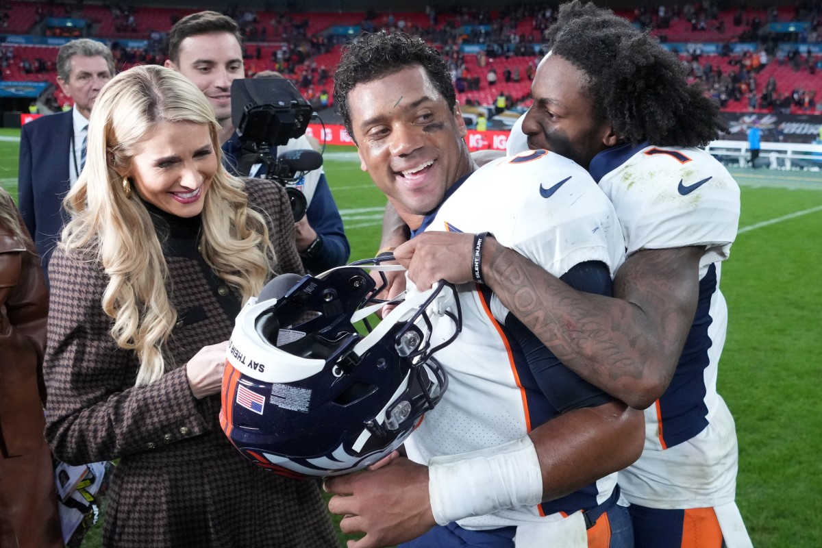 Denver Broncos quarterback Russell Wilson (3) celebrates with wide receiver KJ Hamler (1) as ESPN sideline reporter Laura Rutledge watches after an NFL International Series game against the Jacksonville Jaguars at Wembley Stadium. The Bronco defeated the Jaguars 21-17.