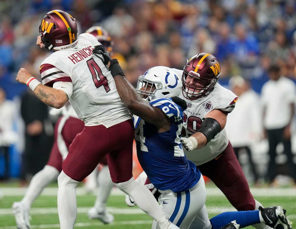 Indianapolis Colts defensive tackle Tyquan Lewis (94) pressures Washington Commanders quarterback Taylor Heinicke (4) as his pass is intercepted Sunday, Oct. 30, 2022, during a game against the Washington Commanders at Indianapolis Colts at Lucas Oil Stadium in Indianapolis.