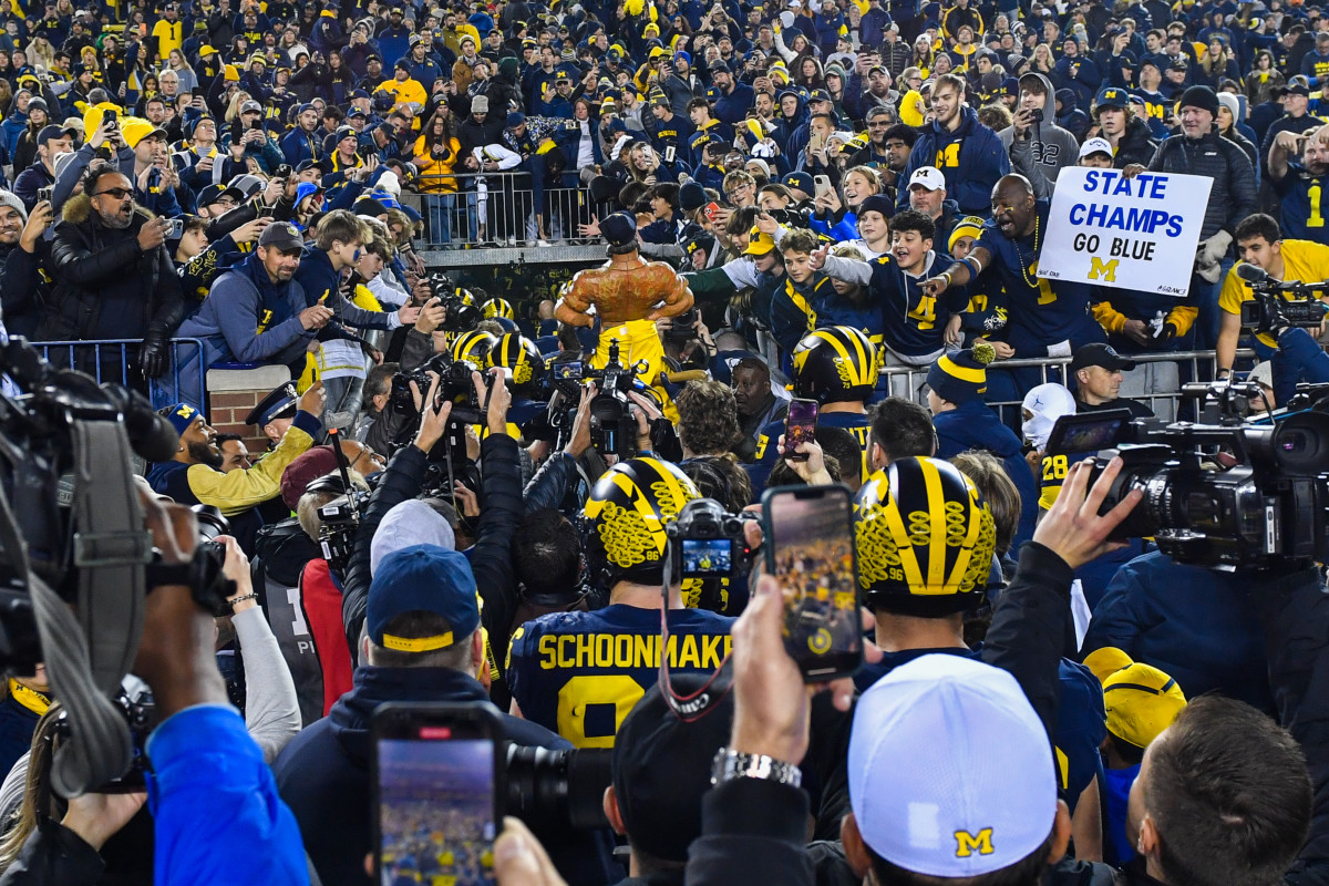 Players cram into the only tunnel at Michigan Stadium after the Wolverines win against MSU.