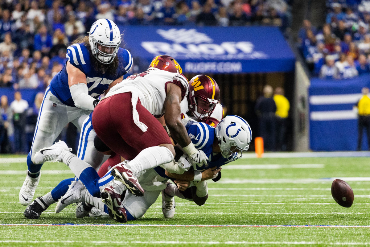 Oct 30, 2022; Indianapolis, Indiana, USA; Indianapolis Colts quarterback Sam Ehlinger (4) fumbles the ball in the second quarter against the Washington Commanders at Lucas Oil Stadium.