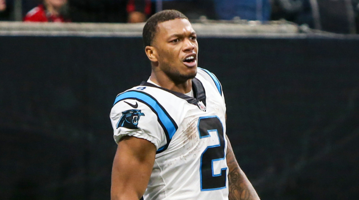 Panthers wide receiver DJ Moore celebrates a touchdown by taking his helmet off.