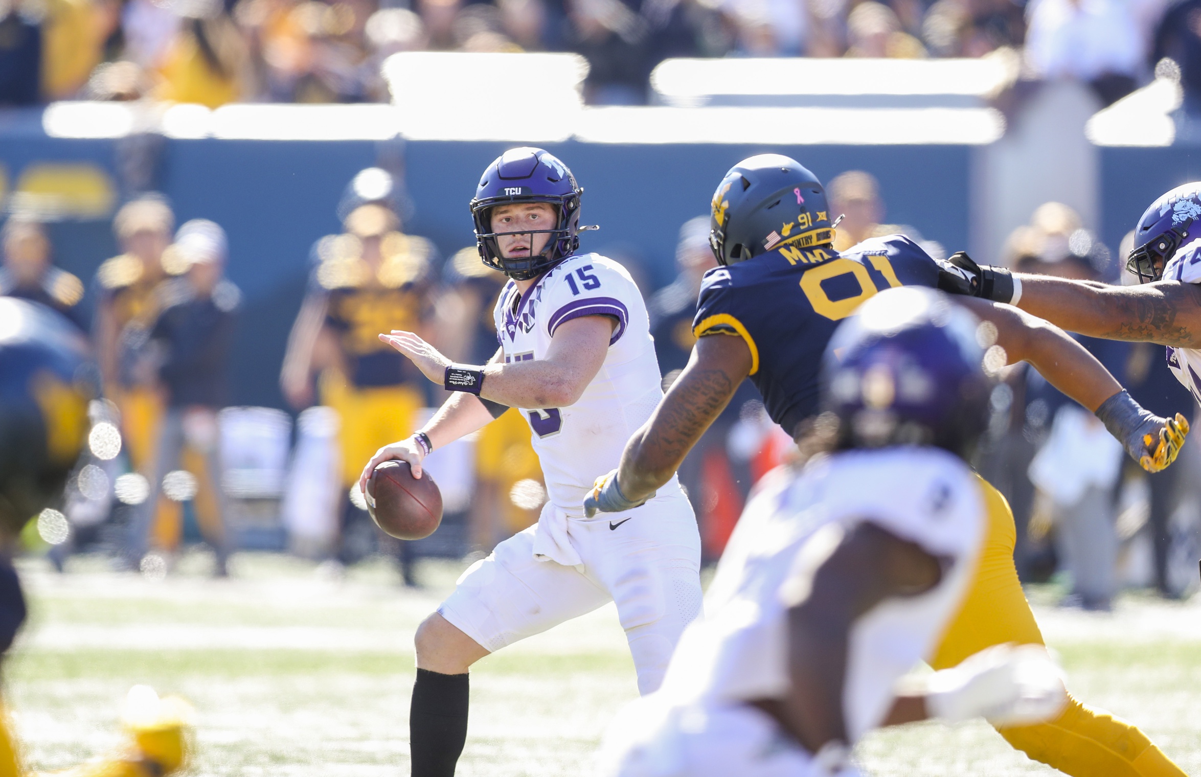 TCU Horned Frogs quarterback Max Duggan (15) rolls out to pass during the second quarter against the West Virginia Mountaineers at Mountaineer Field at Milan Puskar Stadium
