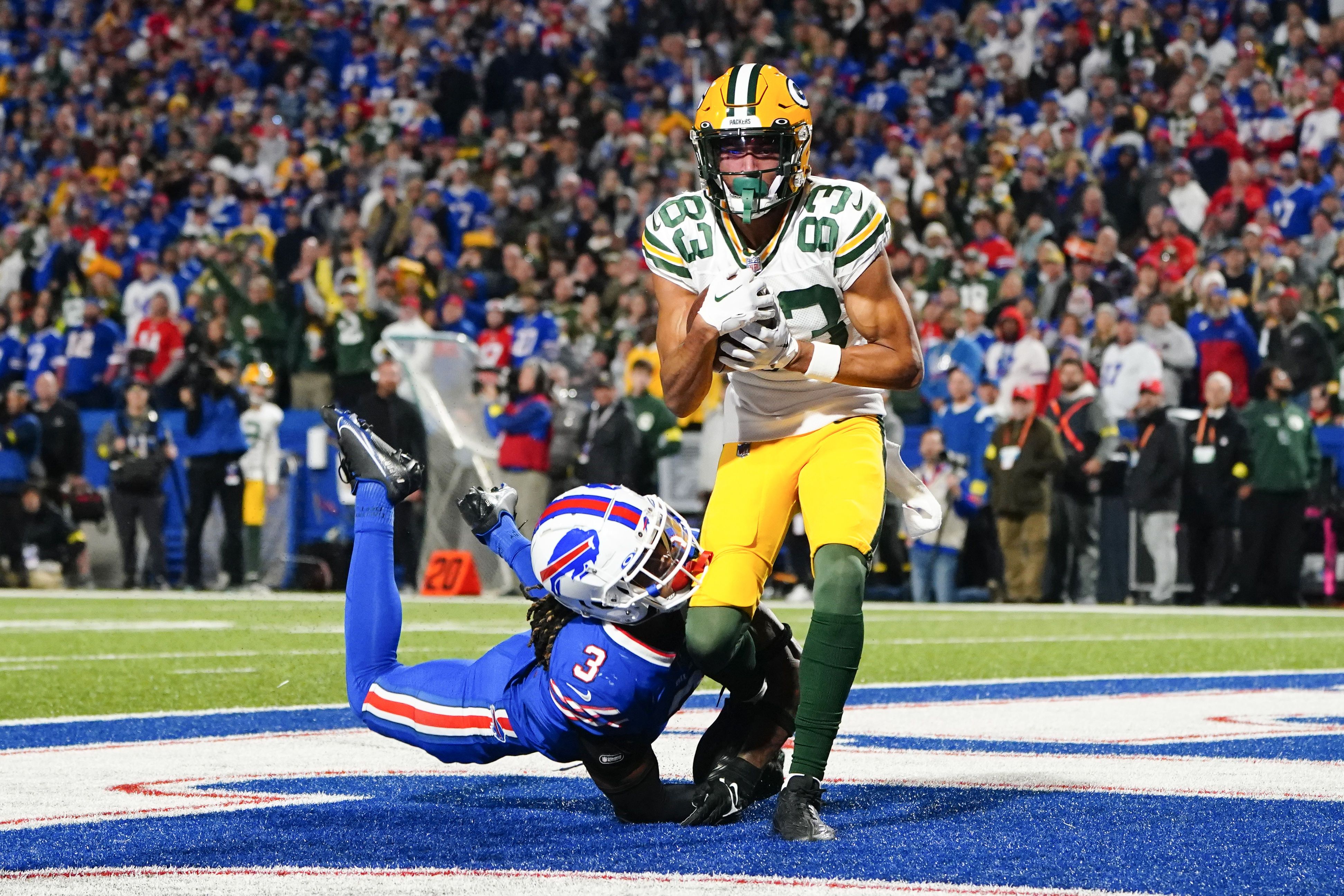Green Bay wide receiver Samori Toure catches a touchdown with a Bills defender trying to grab his leg