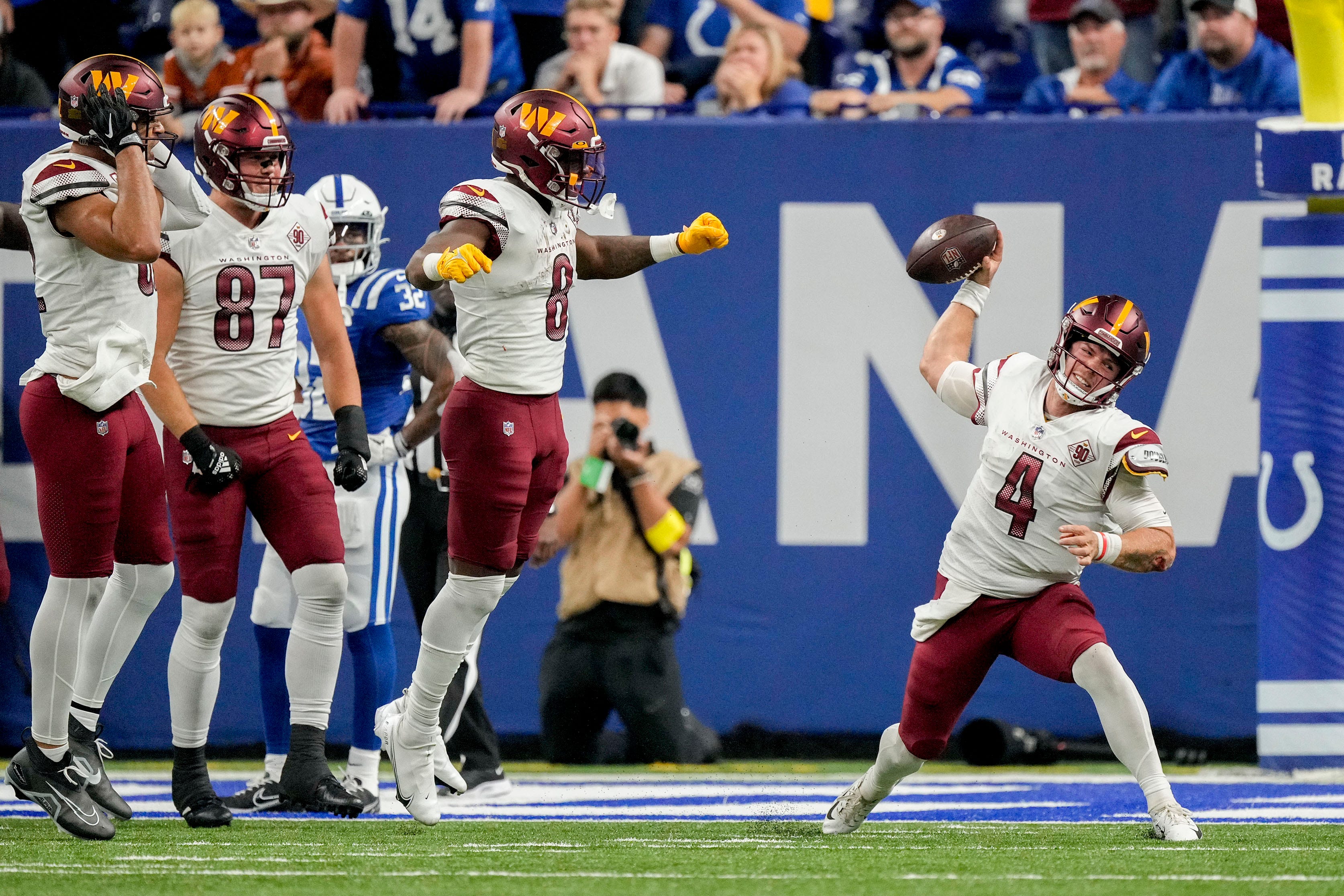 Commanders quarterback Taylor Heinicke spikes the ball in celebration