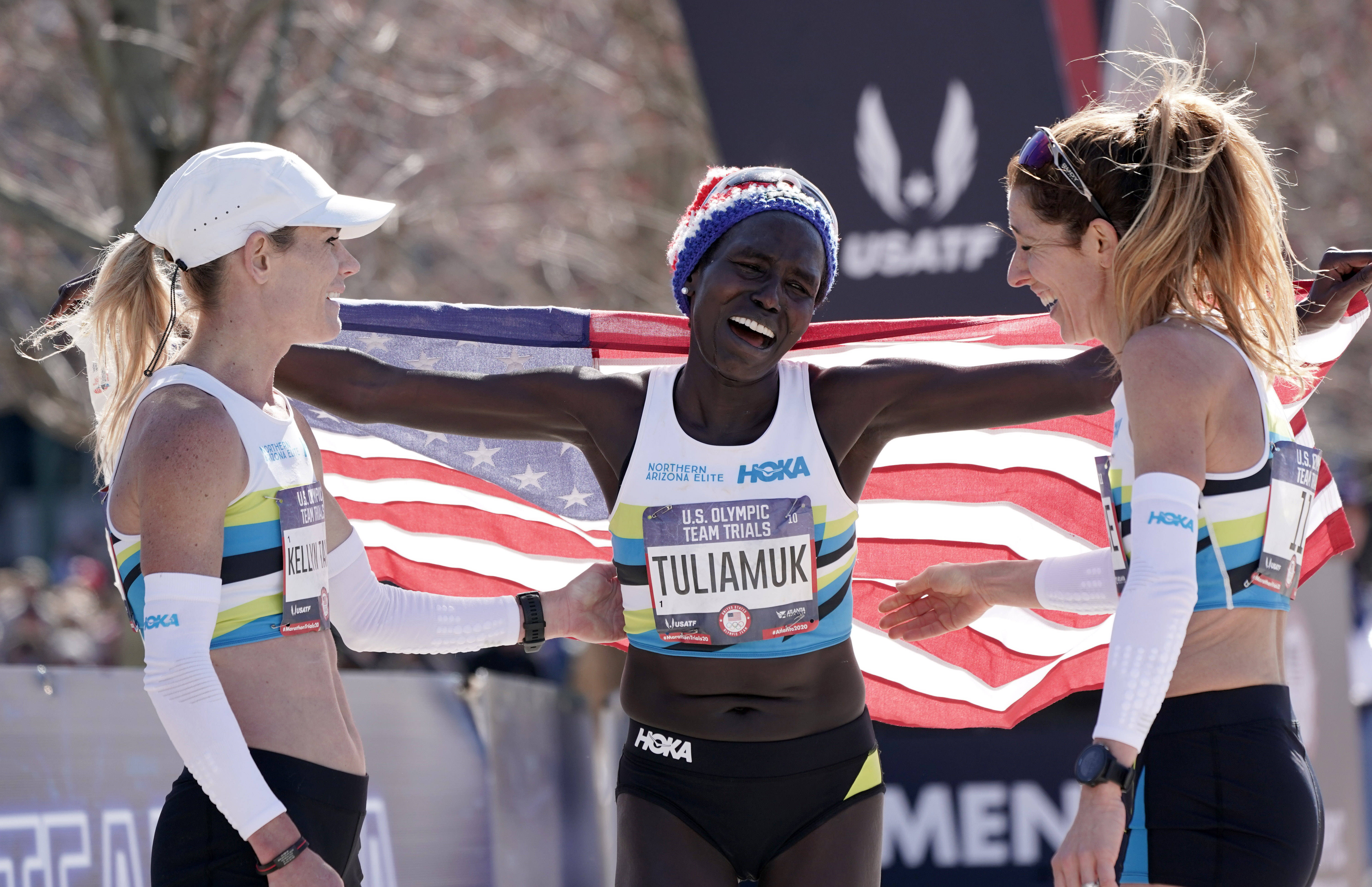 Tuliamuk (center) celebrated with Kellyn Taylor (left) and Bruce after winning the U.S. Olympic Team Trials marathon in 2020.