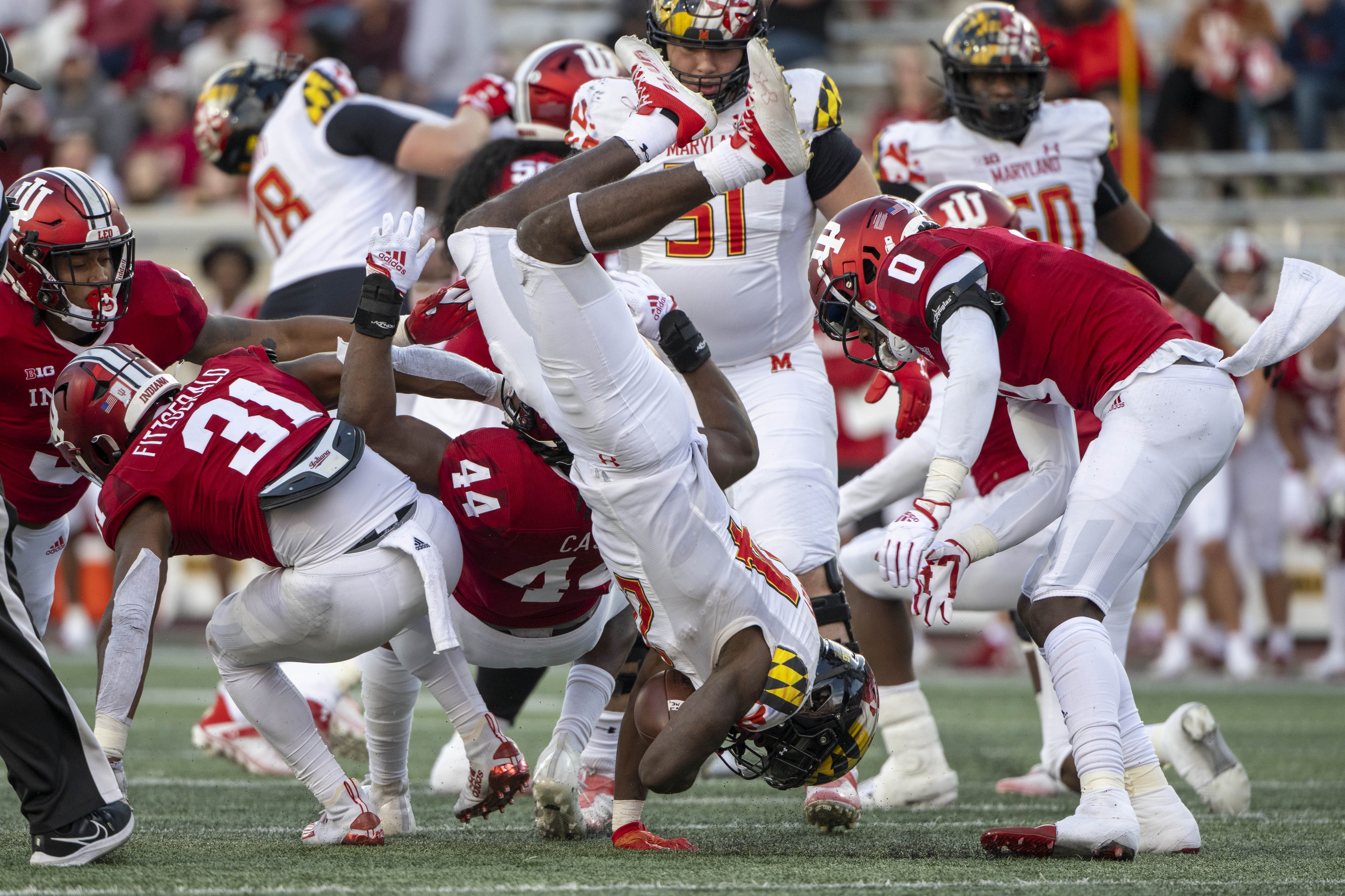 Oct 15, 2022; Bloomington, Indiana, USA; Maryland Terrapins running back Roman Hemby (24) is flipped by Indiana Hoosiers linebacker Aaron Casey (44) during the second half at Memorial Stadium.