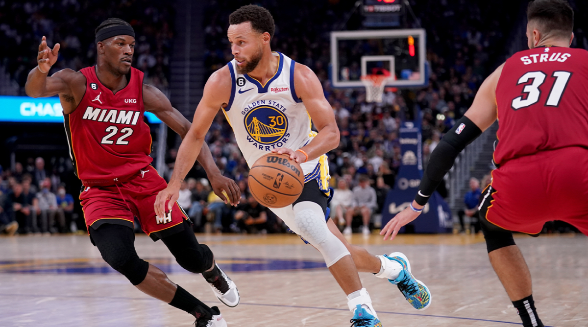 Oct 27, 2022; San Francisco, California, USA; Golden State Warriors guard Stephen Curry (30) drives past Miami Heat forward Jimmy Butler (22) in the third quarter at the Chase Center.