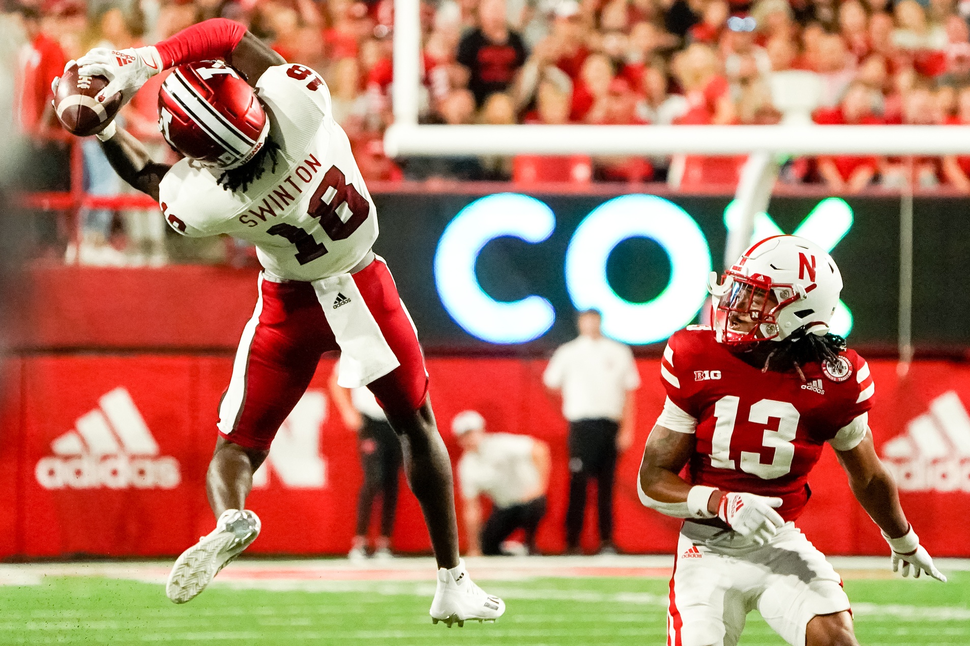 Indiana Hoosiers wide receiver Javon Swinton (18) catches a pass against Nebraska Cornhuskers defensive back Malcolm Hartzog (13) during the second quarter at Memorial Stadium