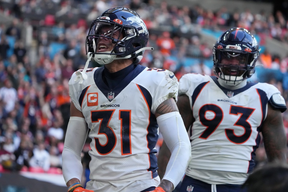 Denver Broncos safety Justin Simmons (31) celebrates with defensive end Dre'Mont Jones (93) after intercepting a pass in the end zone in the second quarter against the Jacksonville Jaguars during an NFL International Series game at Wembley Stadium.