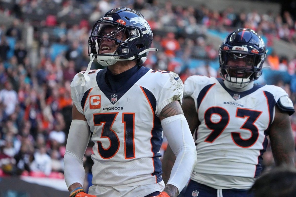 Denver Broncos safety Justin Simmons (31) celebrates with defensive end Dre'Mont Jones (93) after intercepting a pass in the end zone in the second quarter against the Jacksonville Jaguars during an NFL International Series game at Wembley Stadium.