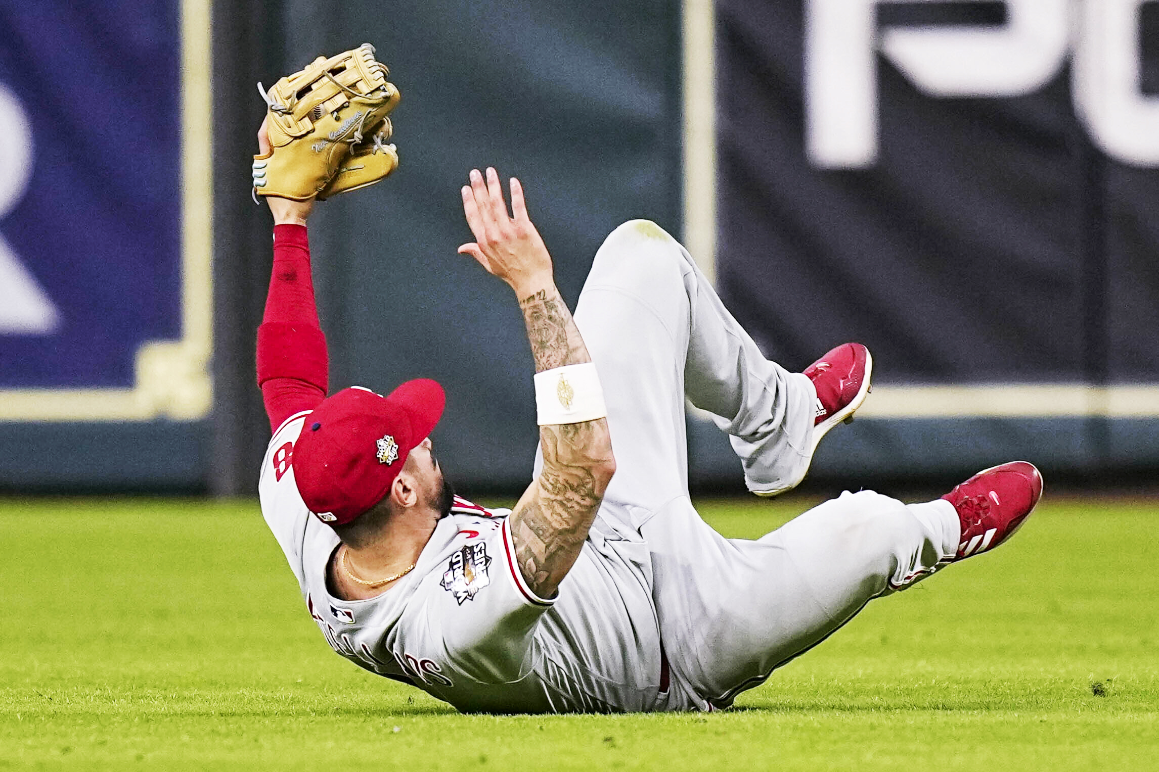 Phillies right fielder Nick Castellanos holds up his arms after making a game-saving sliding catch in Game 1 of the World Series vs. the Astros.