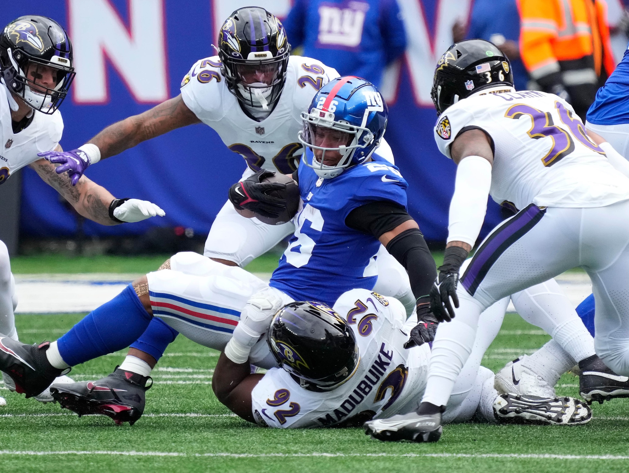 New York Giants running back Saquon Barkley (26) is tackled by Baltimore Ravens defensive tackle Justin Madubuike (92). Mandatory Credit: Robert Deutsch-USA TODAY