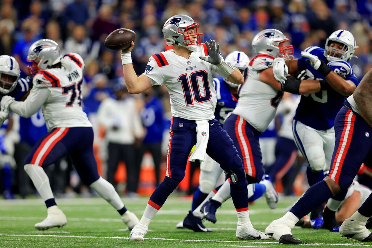 New England Patriots quarterback Mac Jones passes during an NFL game against the Indianapolis Colts on Saturday, Dec. 18, 2021, at Lucas Oil Stadium in Indianapolis.