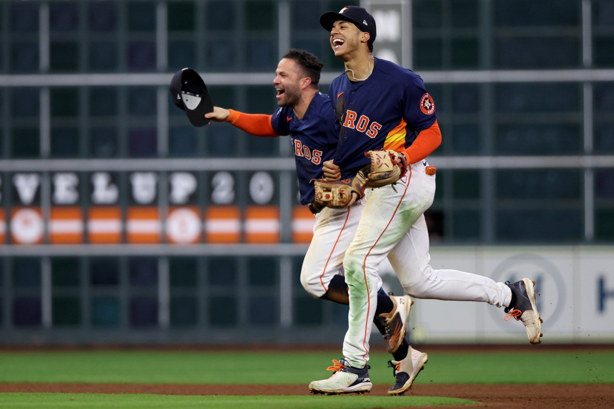Astros second baseman Jose Altuve and shortstop Jeremy Peña celebrate after defeating the Phillies in Game 6 to win the 2022 World Series.