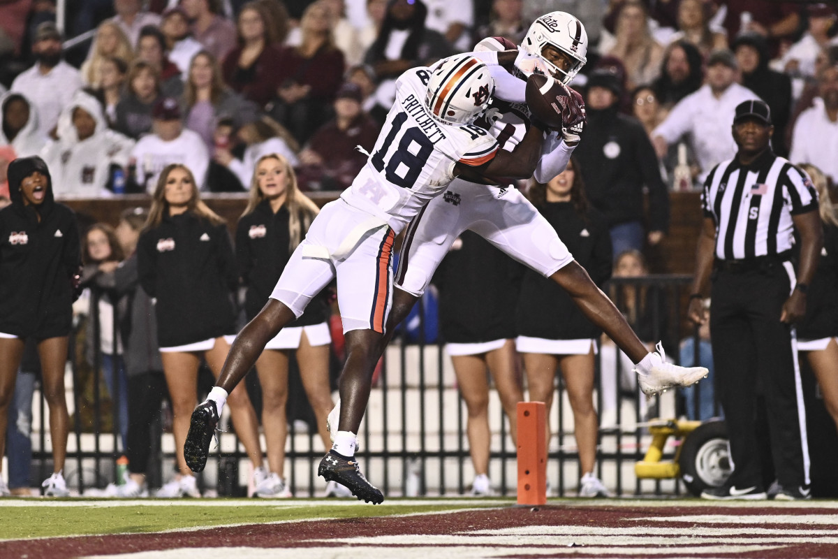 Nov 5, 2022; Starkville, Mississippi, USA; Mississippi State Bulldogs wide receiver Rara Thomas (0) makes a reception for a touchdown while defended by Auburn Tigers cornerback Nehemiah Pritchett (18) during the second quarter at Davis Wade Stadium at Scott Field. Mandatory Credit: Matt Bush-USA TODAY Sports