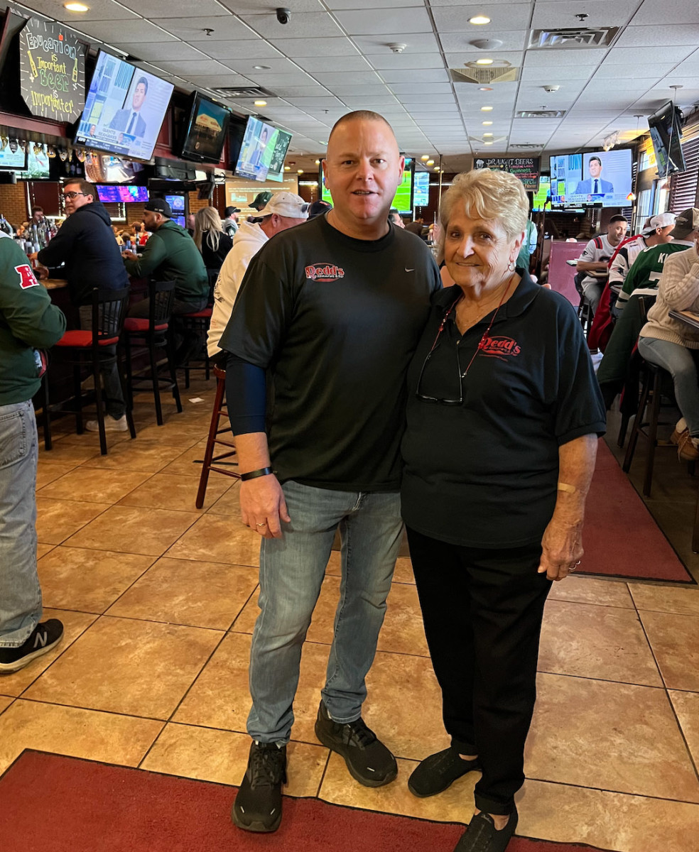 Doug Palsi, owner of Redds bar, poses for a photo with his mom, Tootsie, during an NFL Sunday.