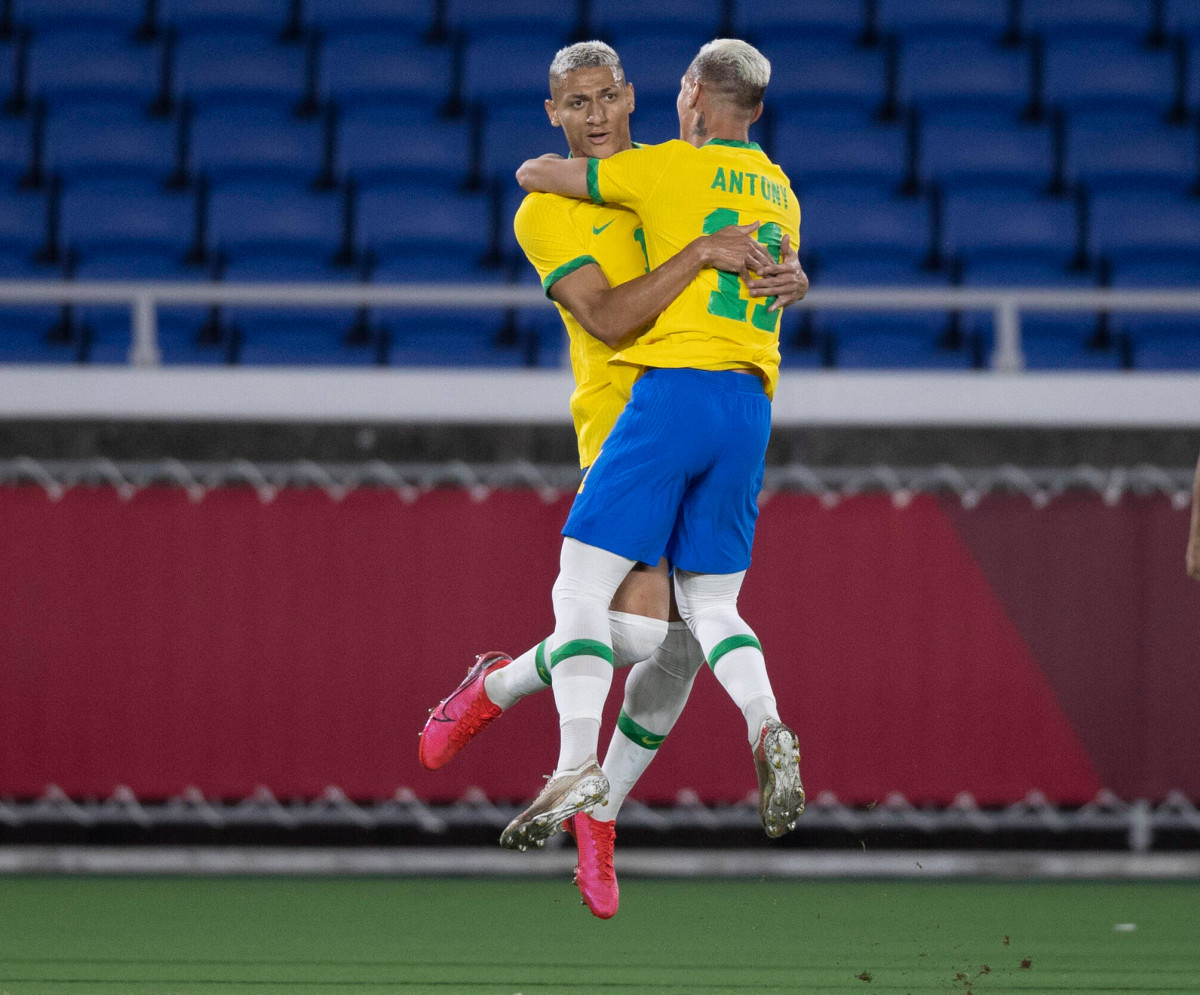Brazil teammates Richarlison (left) and Antony pictured celebrating a goal with a midair hug during the Tokyo Olympic Games in 2021